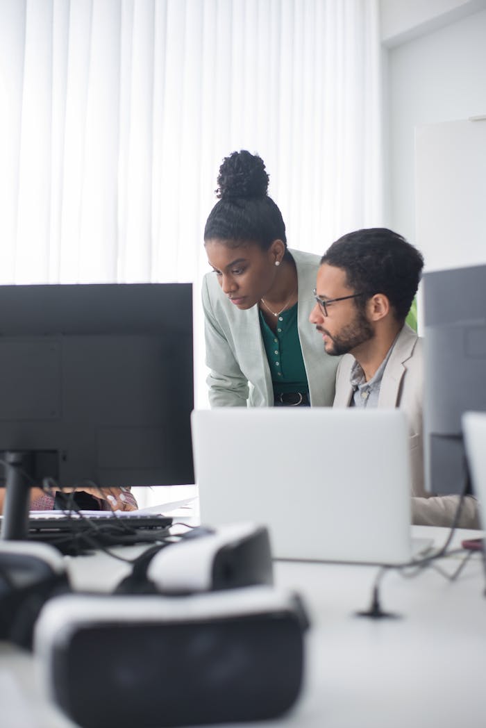 Two professionals collaborate in a modern office setting, promoting teamwork and innovation.